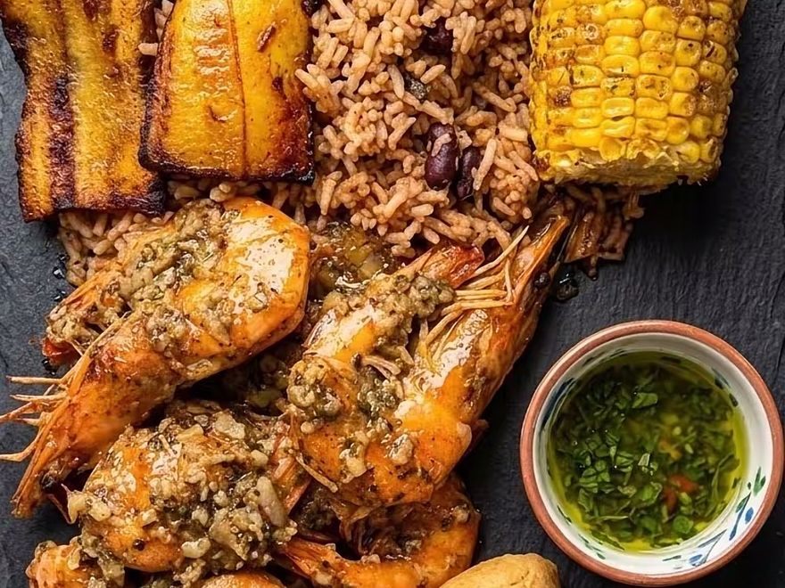 Garlic prawns with plantain, rice and peas, corn and festival